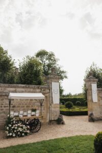 Photo of the seating chart display and linen signs in the reception space at Chateau de Villette in Condécourt, France