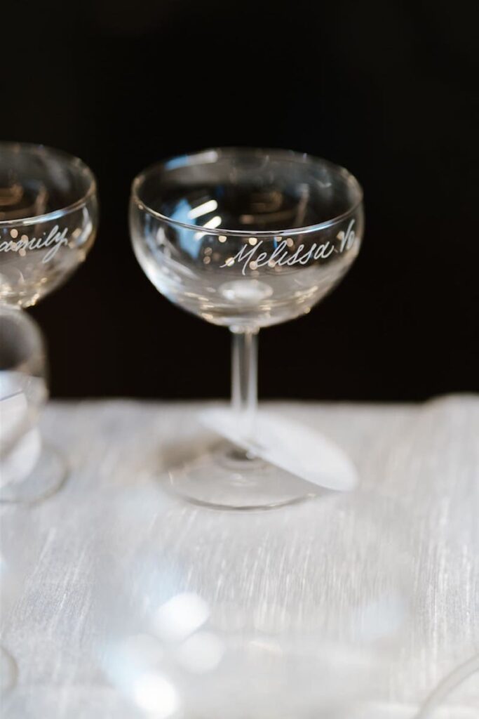 Engraved coupe glasses as personalized wedding favors