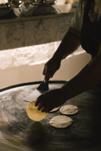Chef flipping handmade tortillas at a welcome party at Chable Yucatan
