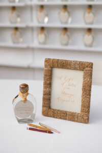 Detail shot of a tequila bottle with a sign that reads "a gift of Sotol from Maxine and Alejandro"